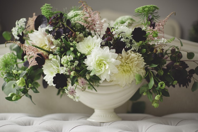 Flowers in a white bowl representing funeral insurance as explained by funeral comparison website Funeralocity